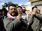 Syrian mourners on Wednesday carried the body of a man who was killed in fighting near Homs. Syrian mourners on Wednesday carried the body of a man who was killed in fighting near Homs.