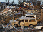 Vehicles and other possessions lie scattered in Harrisburg, Ill. Vehicles and other possessions lie scattered in Harrisburg, Ill.
