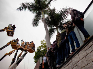 Journalists use cranes to take pictures and videos of the home of chief executive candidate Henry Tang, Feb. 16. After initially denying the allegations, he admitted to building an illegal 2,000-square-foot pleasure palace in his basement, with a wine cellar and a Japanese sauna. Journalists use cranes to take pictures and videos of the home of chief executive candidate Henry Tang, Feb. 16. After initially denying the allegations, he admitted to building an illegal 2,000-square-foot pleasure palace in his basement, with a wine cellar and a Japanese sauna.