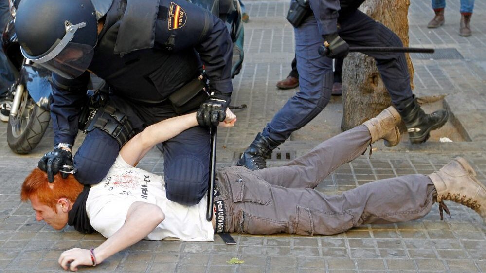 Police restrain a student protesting against education cuts during a rally in Valencia, in eastern Spain, on Feb. 20. Spaniards are beginning to feel the effects of $20 billion in austerity measures, and discontent is growing.