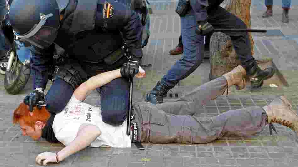 Police restrain a student protesting against education cuts during a rally in Valencia, in eastern Spain, on Feb. 20. Spaniards are beginning to feel the effects of $20 billion in austerity measures, and discontent is growing.