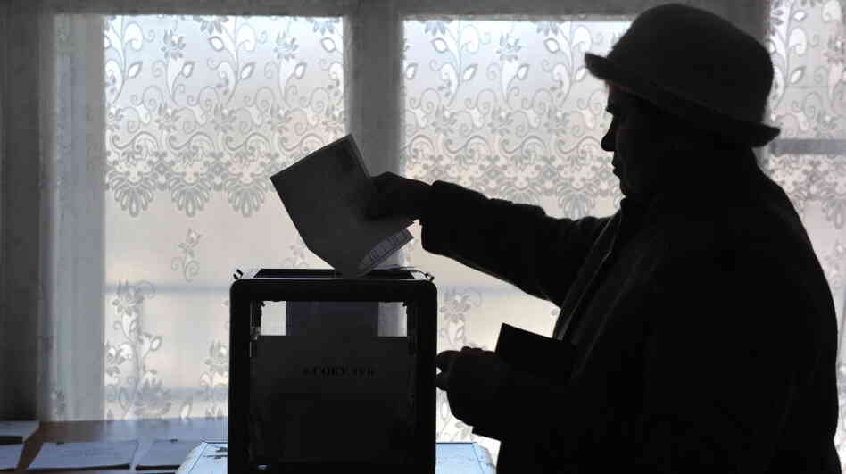 There were widespread allegations of fraud in Russia's parliamentary polls in December. In advance of Russia's presidential election Sunday, Russian citizens abroad have been allowed to vote early. This woman casts a ballot in Kyrgyzstan on Feb. 26.