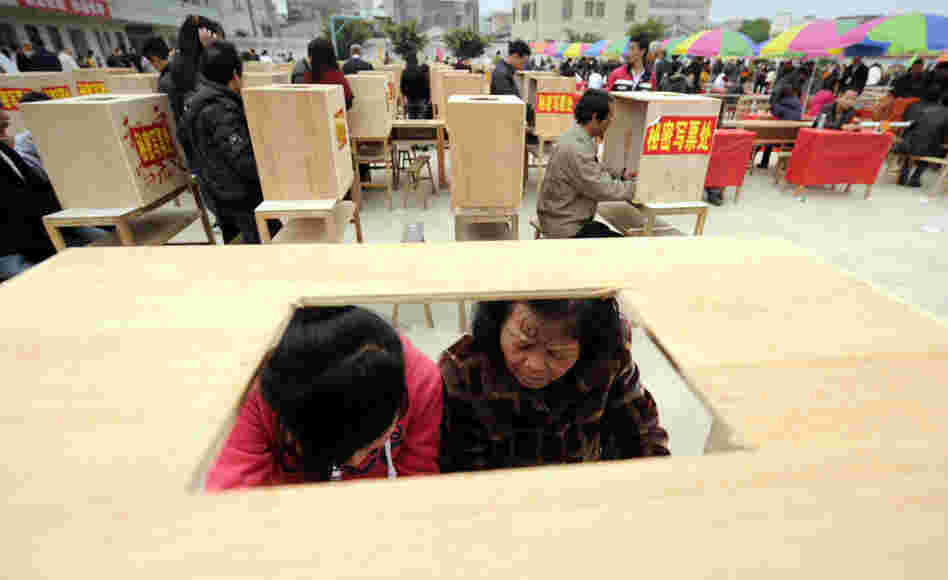 Residents of Wukan in China's southern Guangdong province fill in forms before voting in village elections on Saturday. 