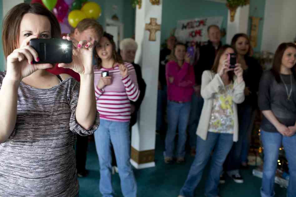 Lorrie Ward, left, joins the family and friends of Ernie Lopez as he enters the family home. Ward was the live-in nanny of Isis Vas, the baby girl who was at the center of Lopez's case. Ward has since become very close to the Lopez family and is a strong supporter of Ernie.