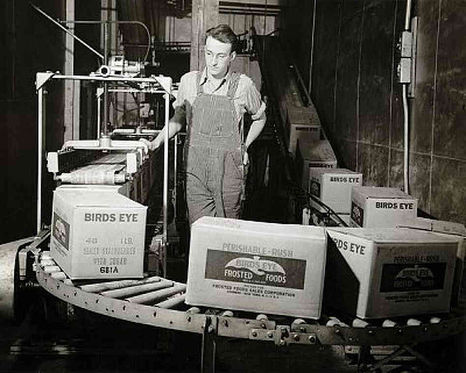 Worker surveys boxes of Bird's Eye frozen foods as they move along a conveyor belt circa 1922-1950. Worker surveys boxes of Bird's Eye frozen foods as they move along a conveyor belt circa 1922-1950.