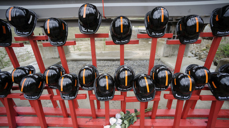 Mine helmets and painted crosses sat at the entrance to Massey Energy's Upper Big Branch coal mine on April 5, as a memorial to the 29 miners killed there one year earlier. Mine helmets and painted crosses sat at the entrance to Massey Energy's Upper Big Branch coal mine on April 5, as a memorial to the 29 miners killed there one year earlier.