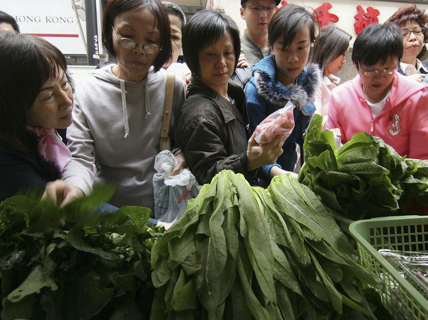 Consumers rush to buy organic products from a farmers market in Hong Kong.
