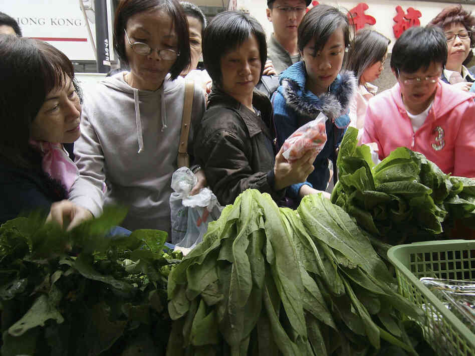 Consumers rush to buy organic products from a farmers market in Hong Kong.
