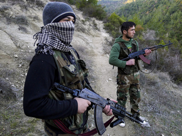 Members of the Free Syrian Army stand guard near the village of Ain al-Baida. The opposition says most of its weapons come from within Syria.