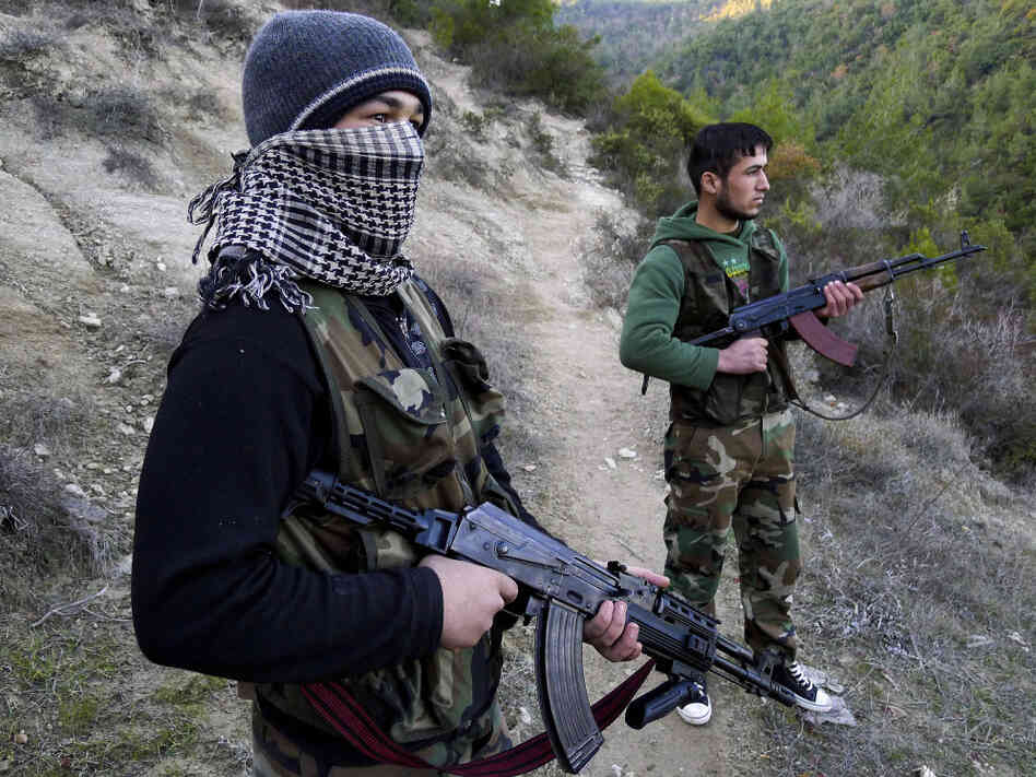 Members of the Free Syrian Army stand guard near the village of Ain al-Baida. The opposition says most of its weapons come from within Syria.