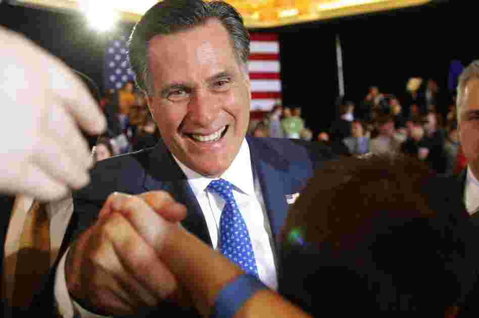 Mitt Romney shakes hands with supporters at his primary election night rally in Boston. Romney won the race in Massachusetts. 