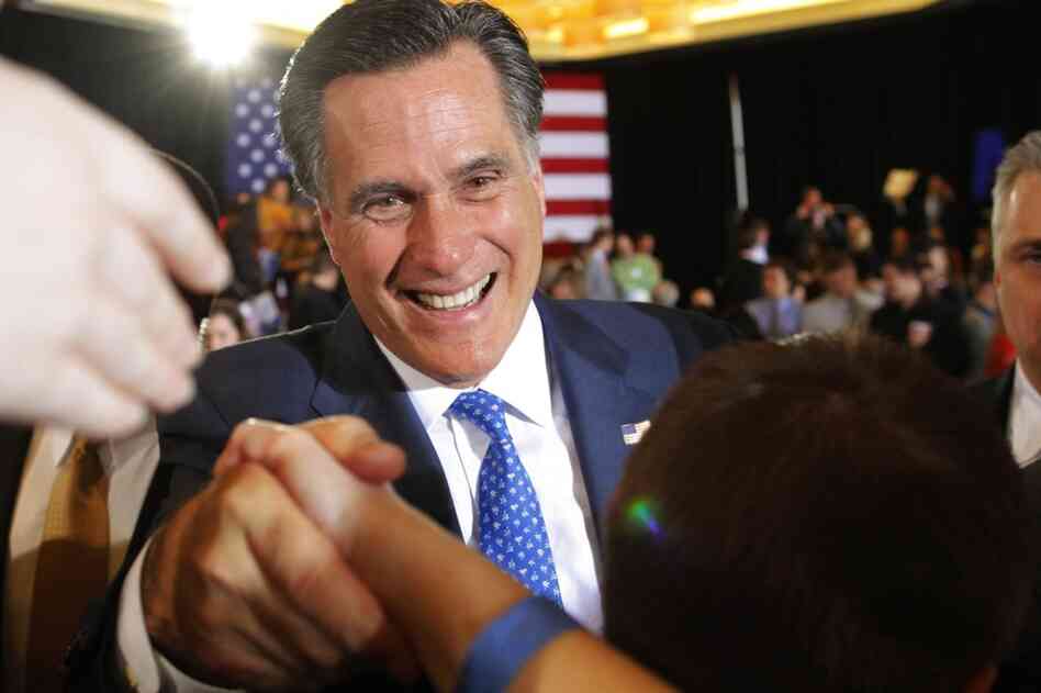 Mitt Romney shakes hands with supporters at his primary election night rally in Boston. Romney won the race in Massachusetts. 