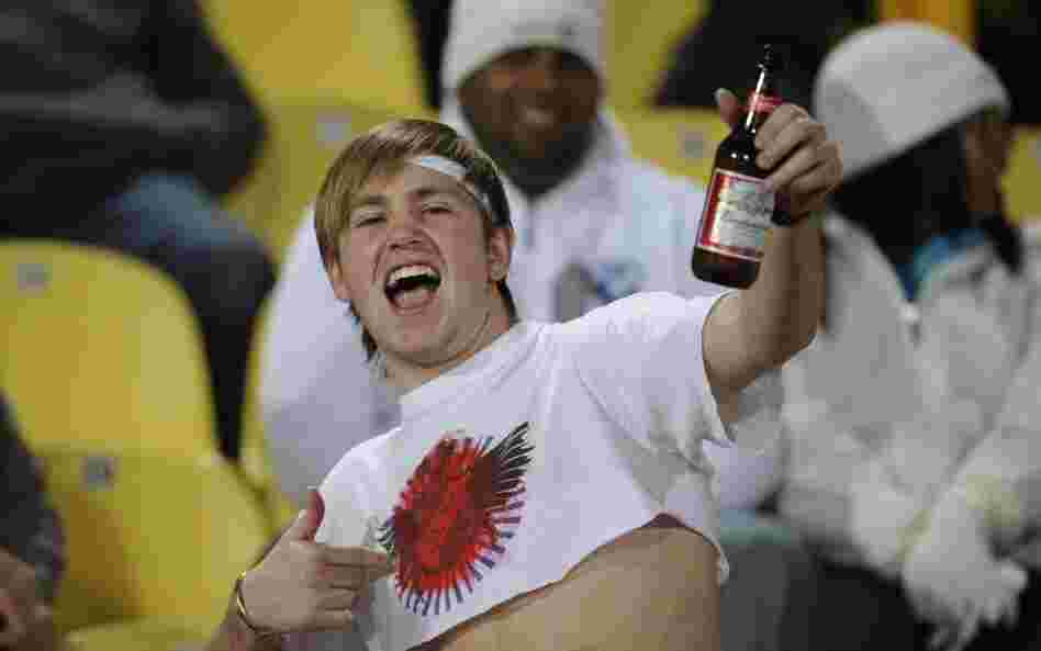 A soccer fan drinks beer before a 2010 World Cup soccer game in South Africa. Budweiser has been the official beer of the FIFA World Cup since 1986 — a role at odds with 2014 World Cup host Brazil's ban on beer at games.