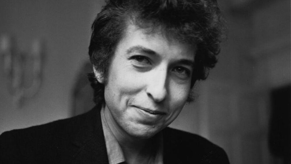 Bob Dylan smiles during a meeting with the British press, April 28, 1965.