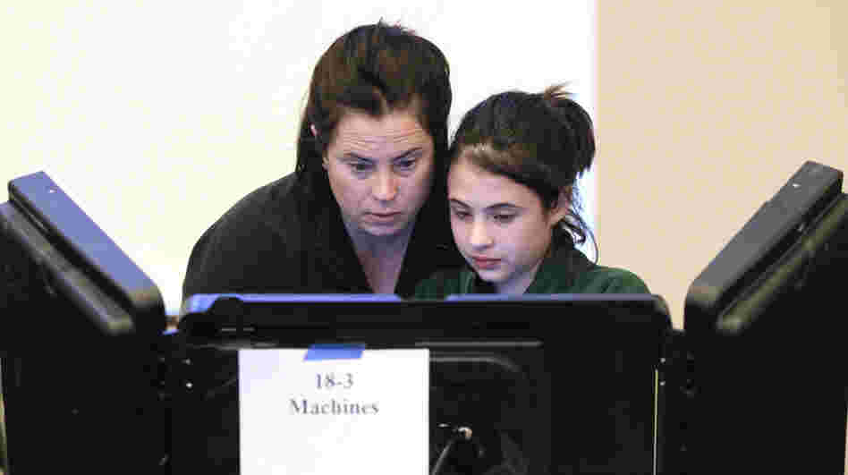 Sally Tepper, 12, watches her mother, Dana, vote in Nashville, Tenn., on Tuesday. Pew experts say Romney trails Obama among women, 38 to 59 percent. Sally Tepper, 12, watches her mother, Dana, vote in Nashville, Tenn., on Tuesday. Pew experts say Romney trails Obama among women, 38 to 59 percent.
