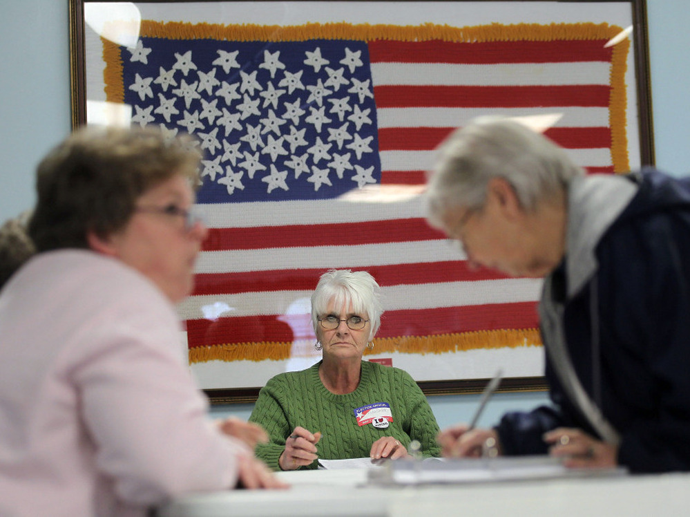 Poll workers assist voters in Carrollton, Ohio, on Tuesday. In the 2010 midterm election, Republicans did better overall among women than Democrats, the GOP's best result among women in 18 years.