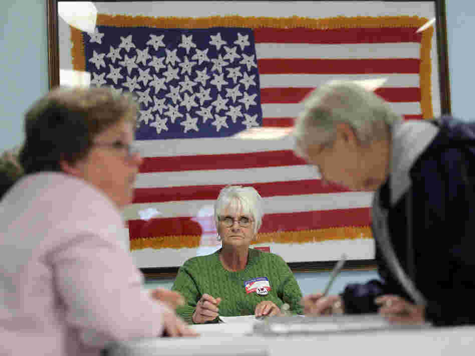 Poll workers assist voters in Carrollton, Ohio, on Tuesday. In the 2010 midterm election, Republicans did better overall among women than Democrats, the GOP's best result among women in 18 years.
