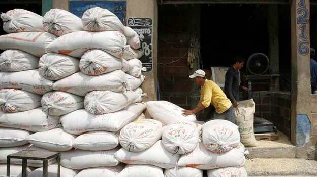 A worker piles sacks of corn at a market in Guatemala City. (Reuters /Landov)