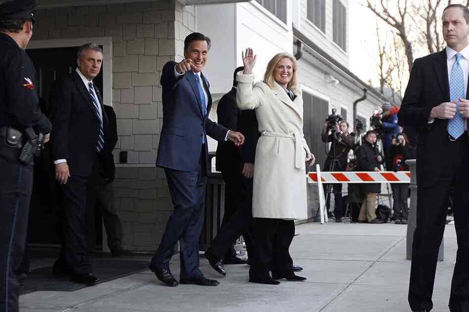 Romney and his wife, Ann, wave to supporters after voting in the Massachusetts primary in Belmont, Mass. 
