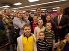Rick Santorum poses with people at Harvest Graphics, a small business, during a campaign stop Wedneday in Lenexa, Kansas. 