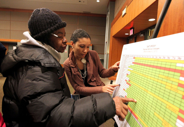 Gladys Ferguson, of Detroit, looks on as SuVon Treece of the Detroit Department of Transportation explains the new service schedule. A public hearing discussed future Detroit Department of Transportation bus service at the Northwest Activity Center on Feb. 24. 