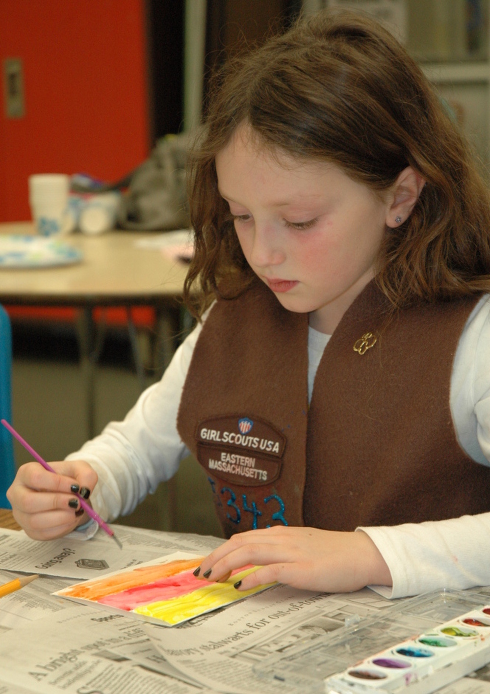 A member of Brownie Troop 65343 works on an art project at a troop meeting. 