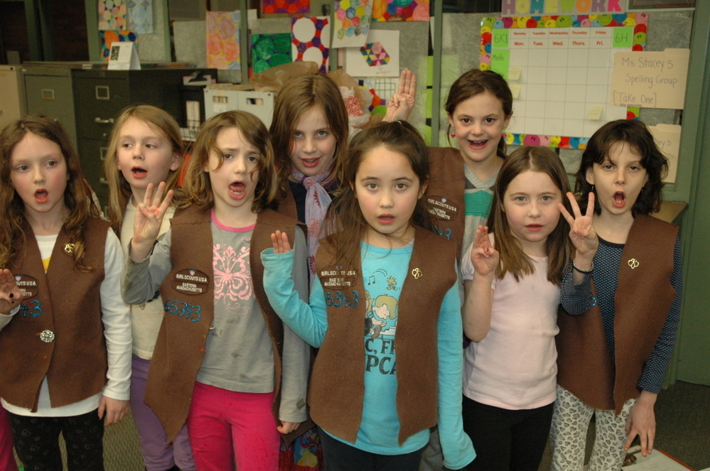 Brownies from Troop 65343 in Brookline, Mass. recite the Girl Scout pledge. Enrollment in the organization has declined since the 1980s, but a modernizing makeover and new focus on minority and immigrant communities have helped some.