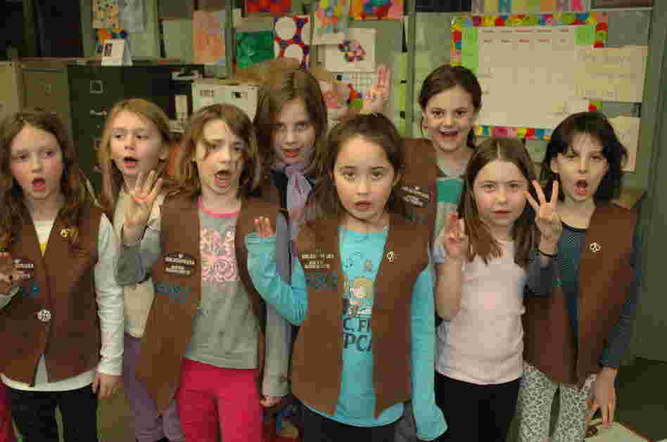 Brownies from Troop 65343 in Brookline, Mass. recite the Girl Scout pledge. Enrollment in the organization has declined since the 1980s, but a modernizing makeover and new focus on minority and immigrant communities have helped some.