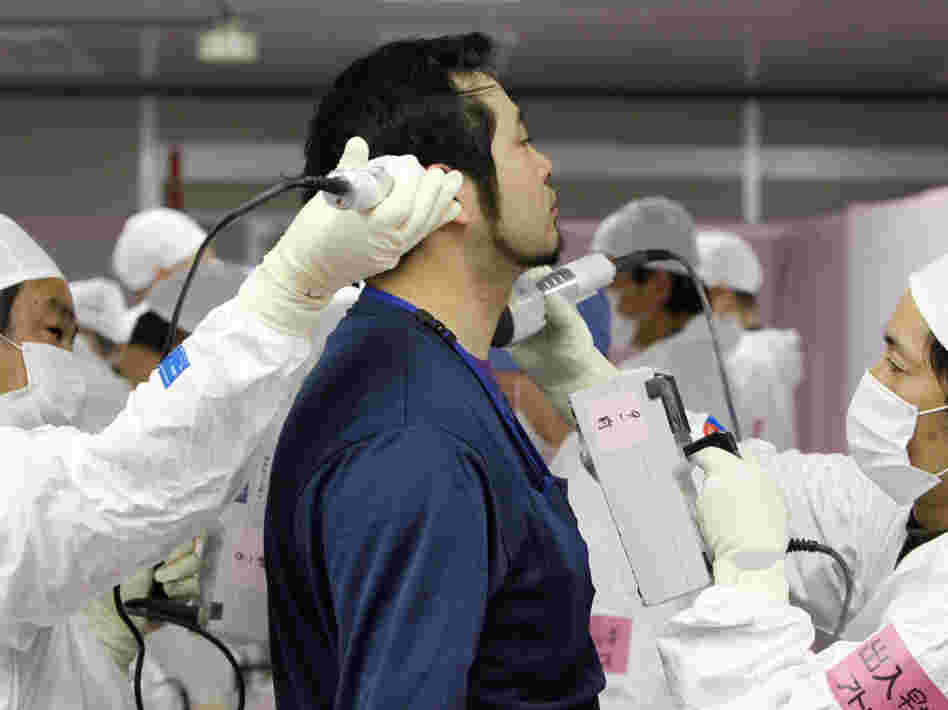A worker is given a radiation screening as he enters the emergency operation center at Tokyo Electric Power Co.'s tsunami-crippled Fukushima Dai-ichi nuclear power plant on Feb. 20. 