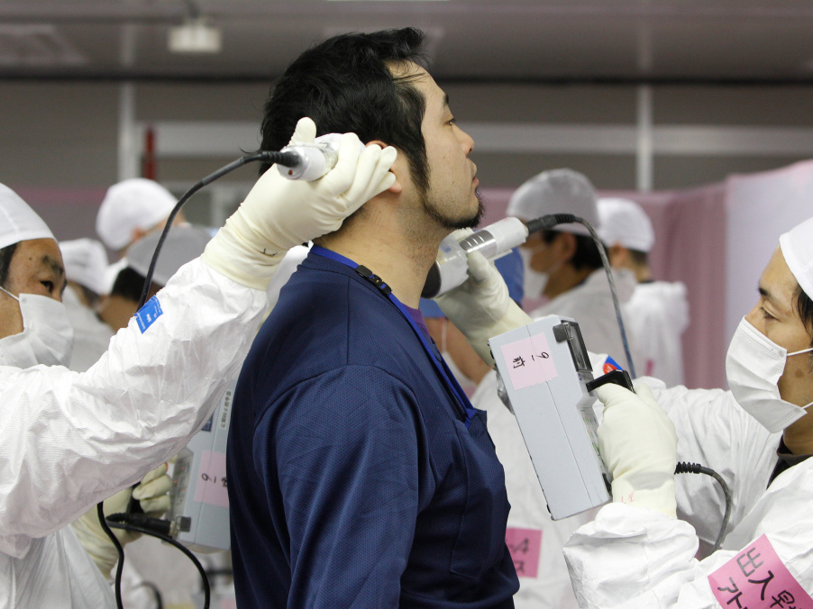 A worker is given a radiation screening as he enters the emergency operation center at Tokyo Electric Power Co.'s tsunami-crippled Fukushima Dai-ichi nuclear power plant on Feb. 20. 