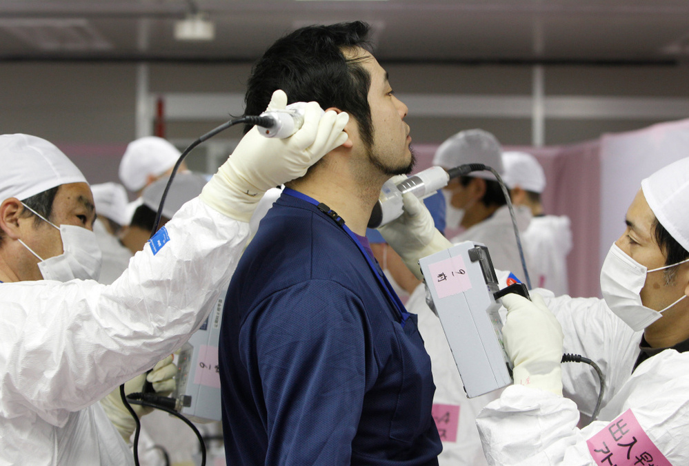 A worker is given a radiation screening as he enters the emergency operation center at Tokyo Electric Power Co.'s tsunami-crippled Fukushima Dai-ichi nuclear power plant on Feb. 20. 