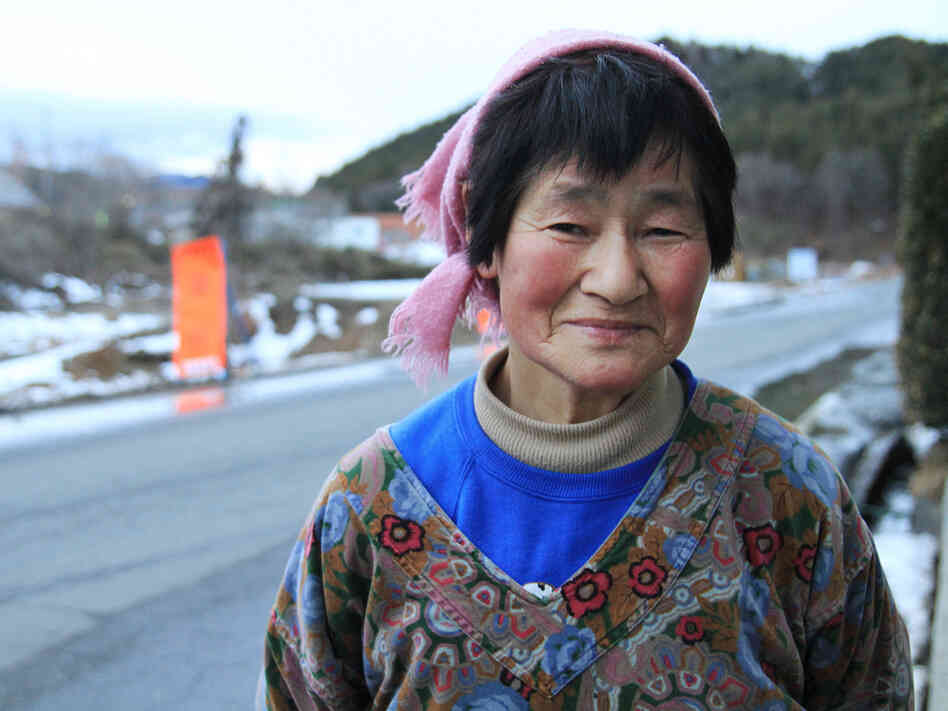 Yoshiko Watanabe stands near where her roadside vegetable stand used to be in Kawauchi village in Japan's Fukushima prefecture. Yoshiko Watanabe stands near where her roadside vegetable stand used to be in Kawauchi village in Japan's Fukushima prefecture.
