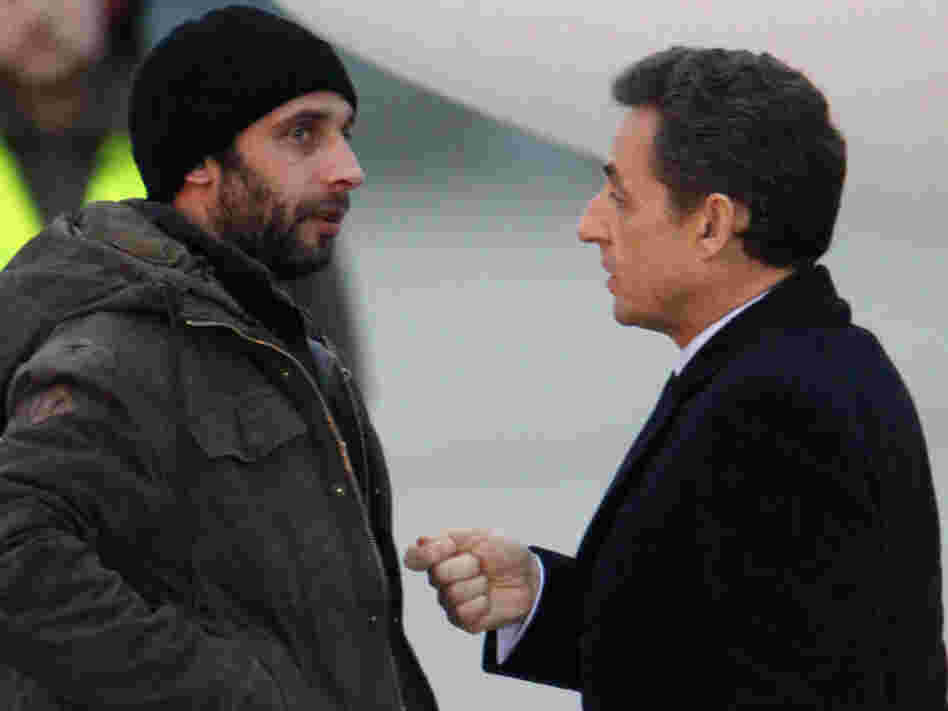 French photographer William Daniels (left) speaks with France's President Nicolas Sarkozy at a military airport outside Paris on March 2, just after escaping from Syria via Lebanon.