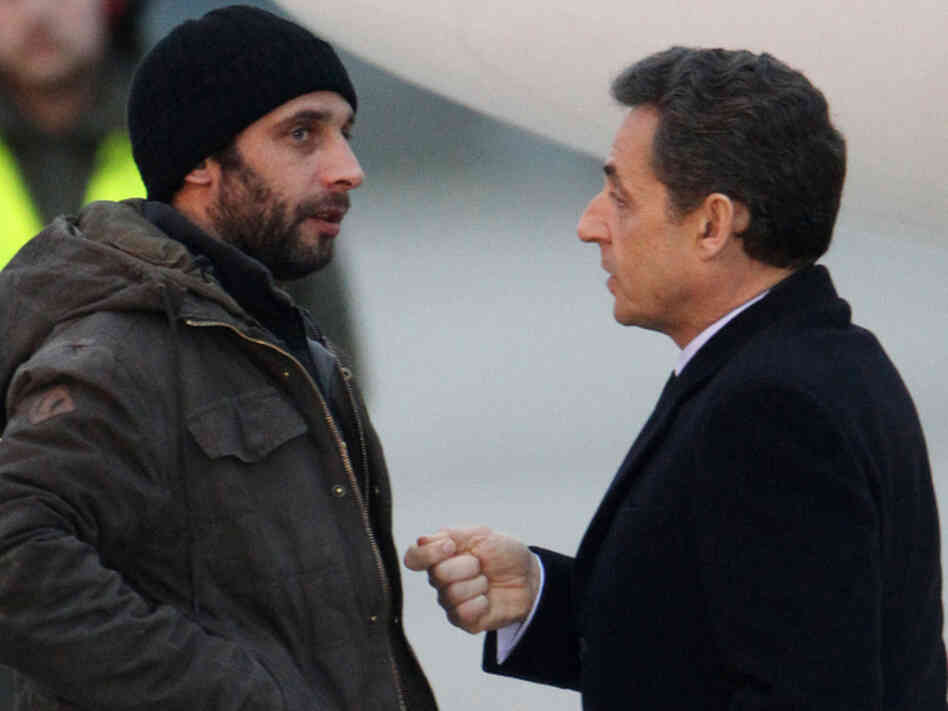 French photographer William Daniels (left) speaks with France's President Nicolas Sarkozy at a military airport outside Paris on March 2, just after escaping from Syria via Lebanon.