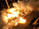 The artist and volunteers watch the explosion set off by the ignition of the gunpowder drawing, Desire for Zero Gravity. The artist and volunteers watch the explosion set off by the ignition of the gunpowder drawing, Desire for Zero Gravity.
