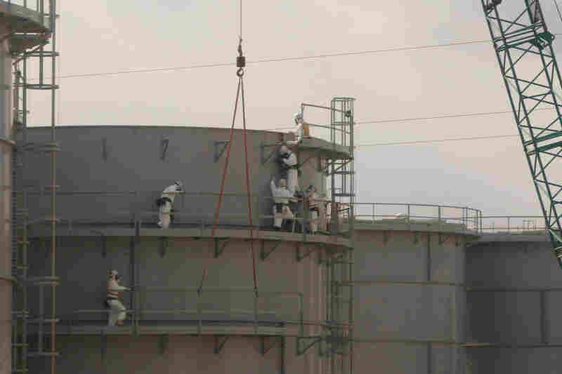 Workers assemble water tanks at the power station on Feb. 20. Engineers plan to flood the reactors, which will give them safe access to the nuclear fuel.