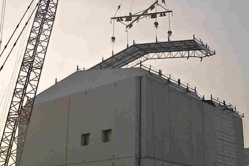 A huge iron tent is constructed over one of the reactor buildings at the facility in October. Cleanup efforts could continue for decades.