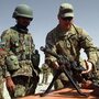 A U.S. soldier instructs Afghan soldiers in the western city of Herat last July. Afghans in security force uniforms have killed a number of U.S. and NATO troops recently. The shootings come as NATO works to prepare the Afghan forces to take control of security. 