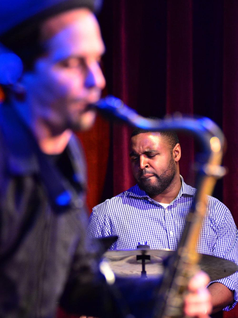 Kendrick Scott, through the crook of John Ellis' saxophone.