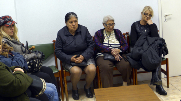 Patients sit in the waiting room of a free medical clinic in Perama, Greece, run by an international aid group, Doctors of the World, last month. Official unemployment in the port town is 80 percent, and many people are unable to afford food and medicine. Patients sit in the waiting room of a free medical clinic in Perama, Greece, run by an international aid group, Doctors of the World, last month. Official unemployment in the port town is 80 percent, and many people are unable to afford food and medicine.