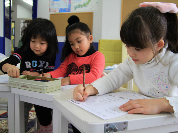 Students draw during art class at Imagine Japan, an English-language school in Sendai City, Japan. Immediately following last year's earthquake and tsunami in northeast Japan, a teacher observed some of the kids drawing faces and bodies with black markers.