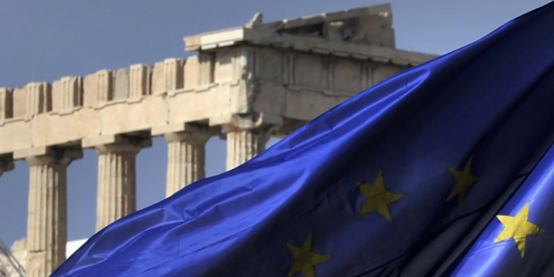 The European Union flag flies in front of the Parthenon in Athens. Greece's EU partners are about to give it another massive bailout.