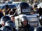 A protester wearing a costume bearing the words Robocop walks among Russian riot police officers after a rally in Moscow on Saturday. A protester wearing a costume bearing the words Robocop walks among Russian riot police officers after a rally in Moscow on Saturday.