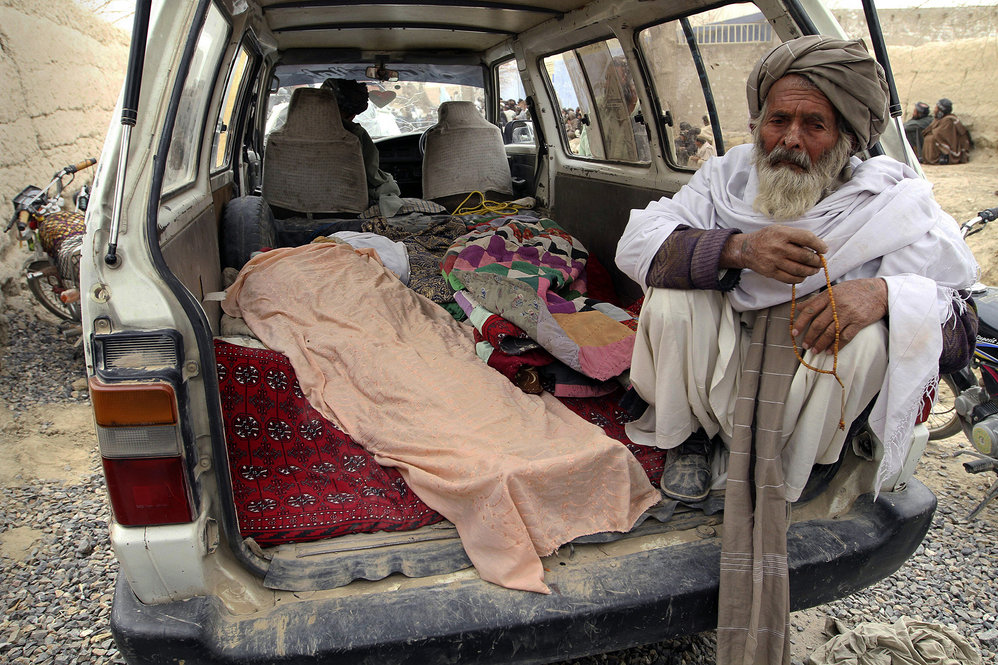 Villagers display the bodies of those allegedly killed when an American soldier opened fire on Afghan civilians. 