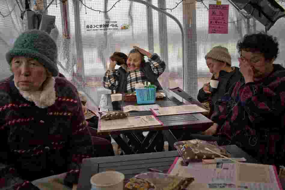 Women mingle at a community center that was set up in a tent.