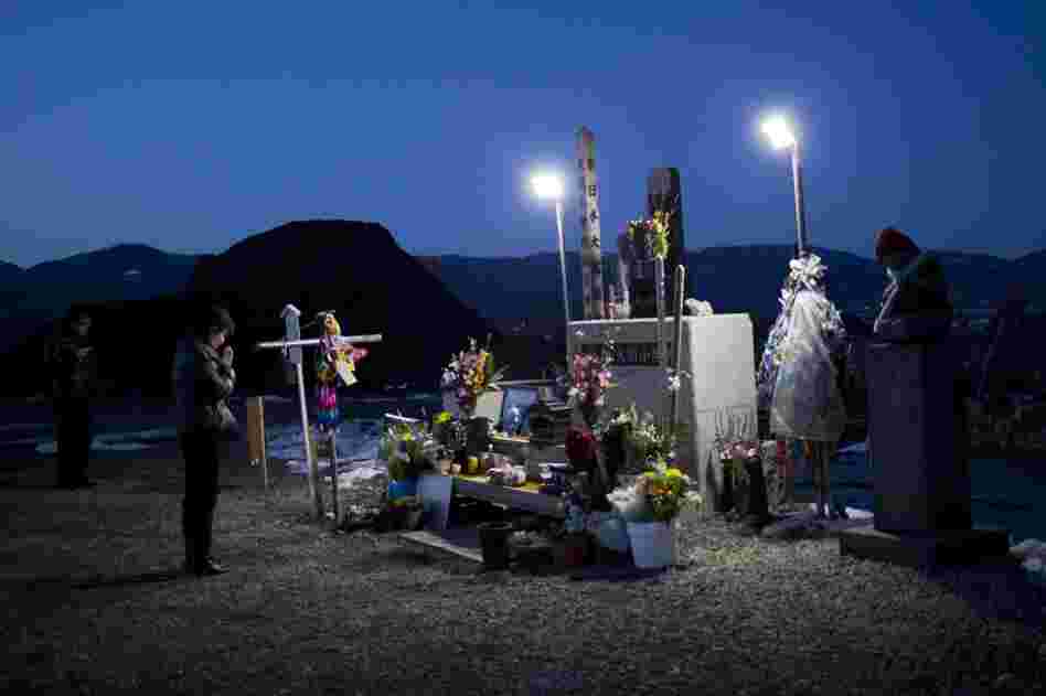 A woman prays at a shrine commemorating the victims of the Okawa tragedy.