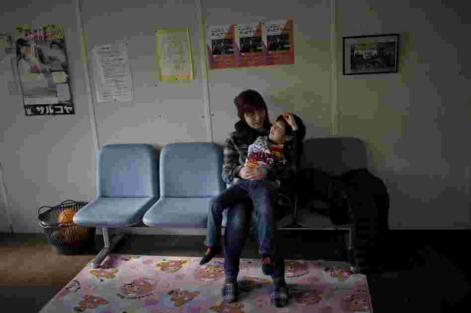 Naomi Tsuda and her 5-year-old son, Shohei, wait for her 10-year-old-daughter, Kyoka, to finish her piano lesson.