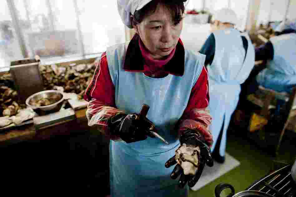 Farmer Yoshitaka Abe's wife, Yumiko, 54, works in an oyster factory.