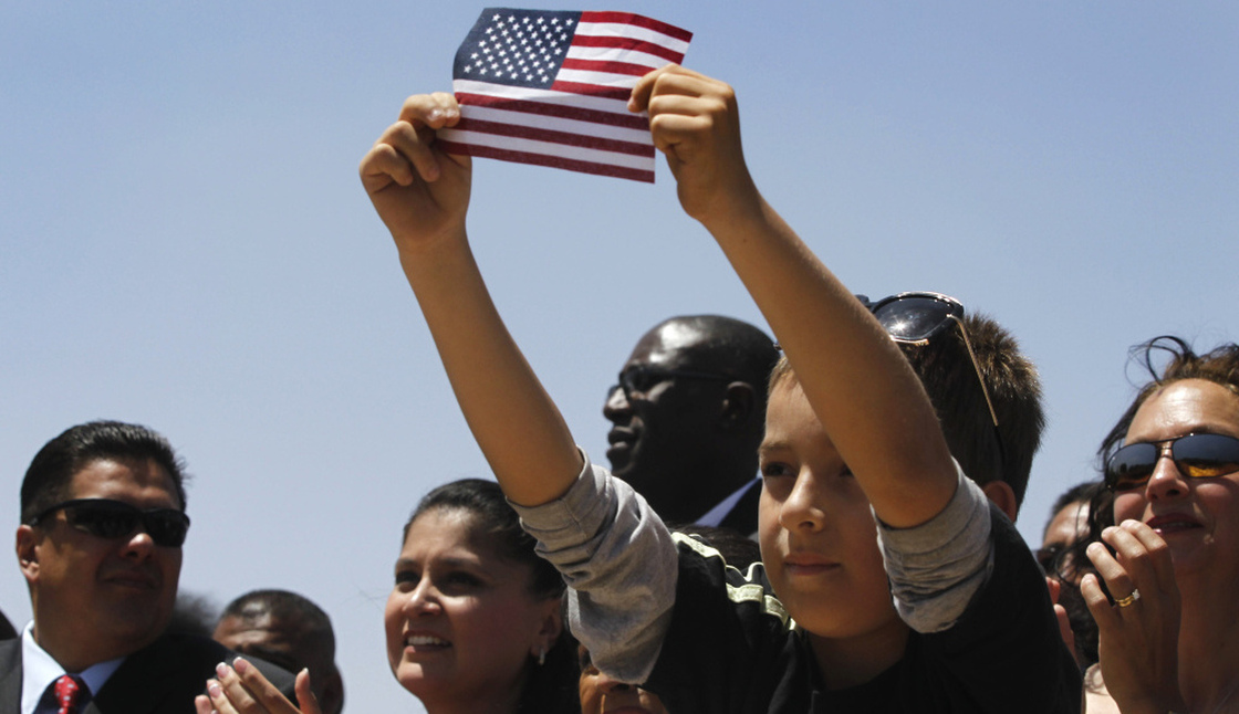 Audience members listen to President Obama talk about immigration in 2011 in El Paso, Texas. Hispanic voters face a choice this election season: continue to support Obama despite being disproportionately hurt by the economic downturn, or turn to Republicans at a time when many GOP presidential hopefuls have taken a hard line on immigration. 