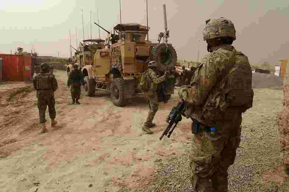 U.S. soldiers keep watch at the entrance of a military base near Alkozai village. 
